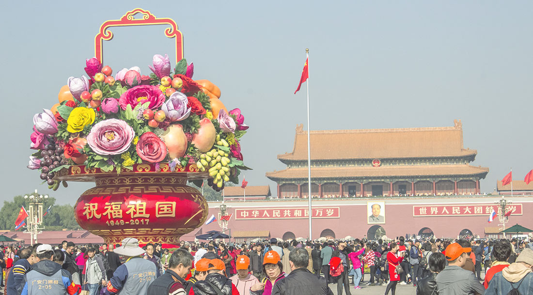 A huge and colorful flower vase stands in front of the Forbiden City in Tiananmen Square.